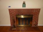 Here is a close-up of the pretty wood-burning fireplace in the living room.
