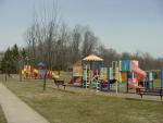A colorful community playground is located near the entrance to Regalwood Terrace.