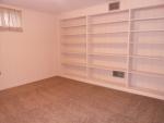 This is the den with a full wall of shelving that would be great for a library or office.